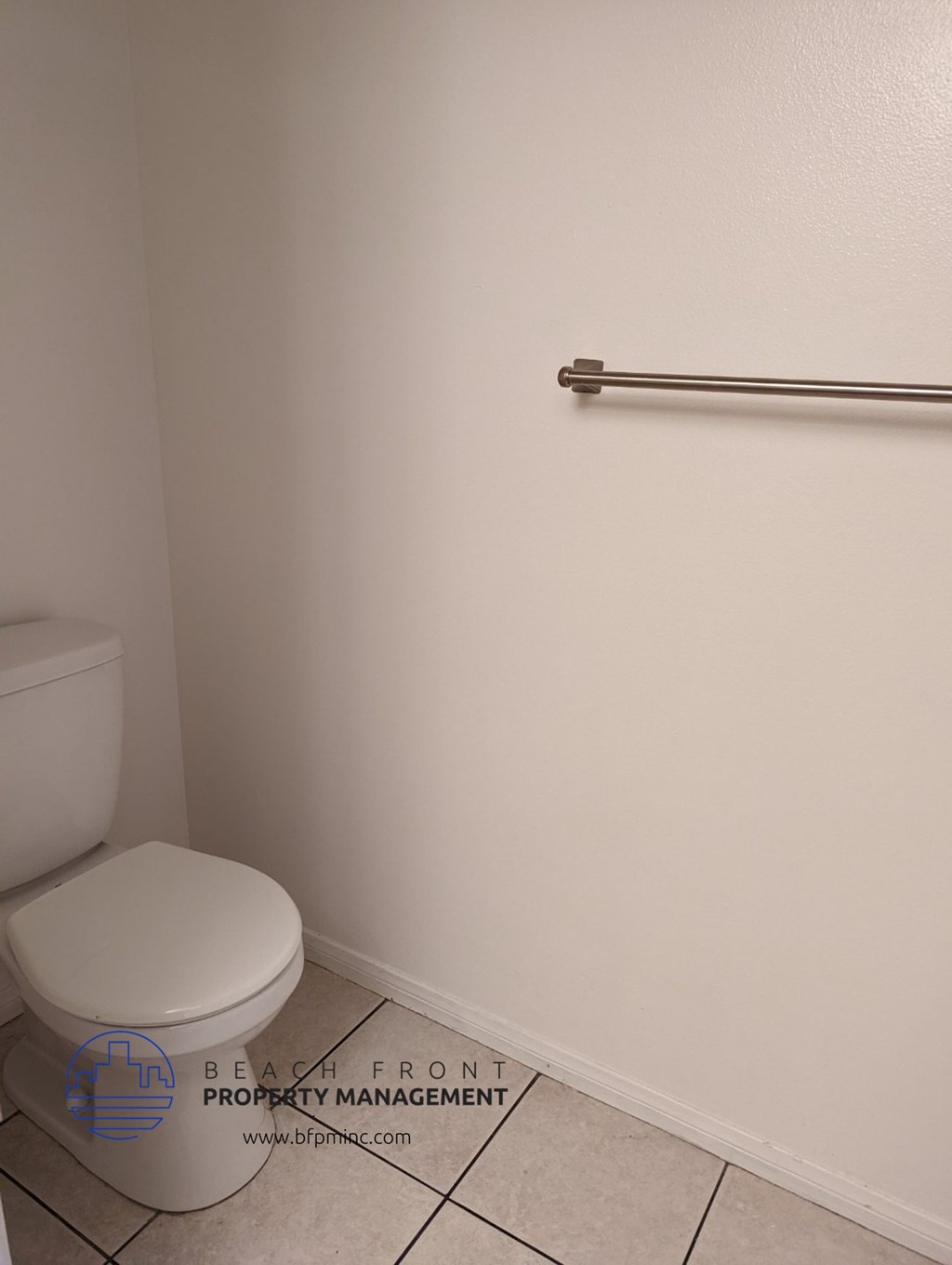 a bathroom with a toilet and a handicap rail